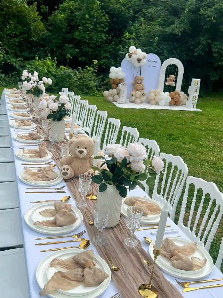 A Long Garden Table With a Teddy Bear Down the Middle