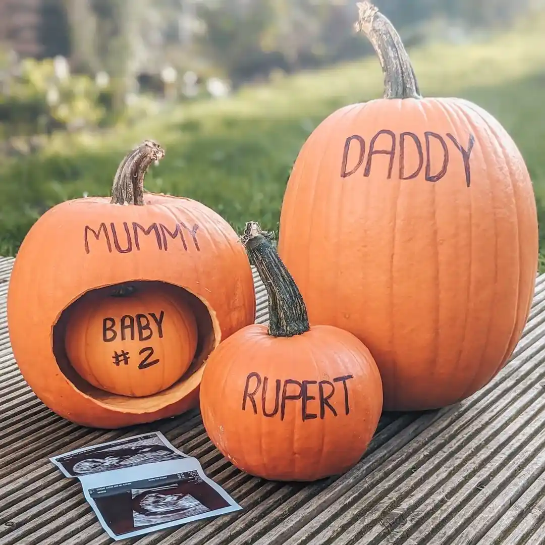 Three pumpkins labelled Mummy, Daddy and Rupert with a small pumpkin tucked inside Mummy marked Baby number 2, beside an ultrasound print