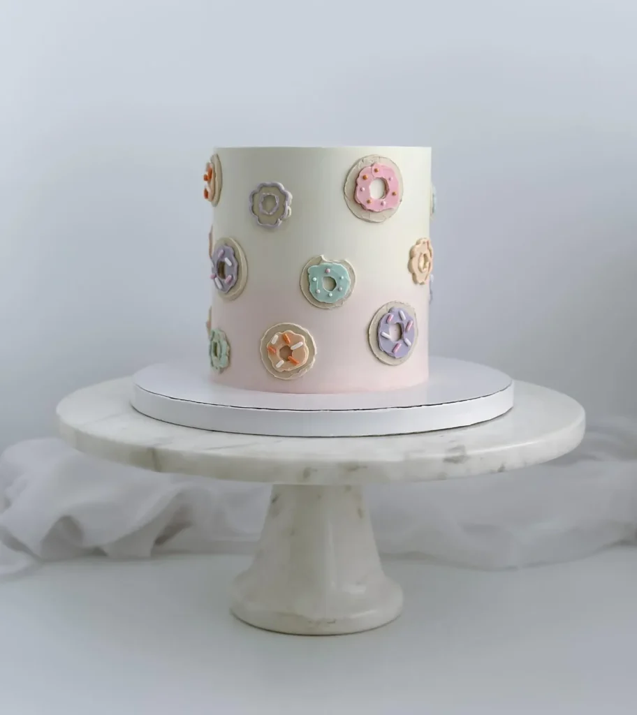 Pastel Donuts Stuck Flat on the Side of a Tall Cake