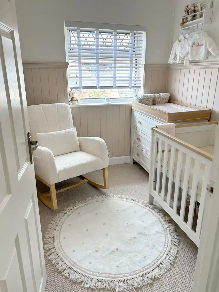Blush Paneling and a Round Rug in a Tiny Room