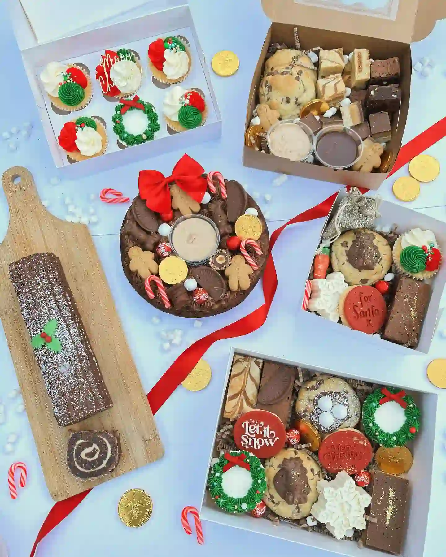 Table of round cheesecakes with different toppers: raspberry sauce with white chocolate shards, caramel drip with spiced biscuits and chocolate drip with dark chocolate shards