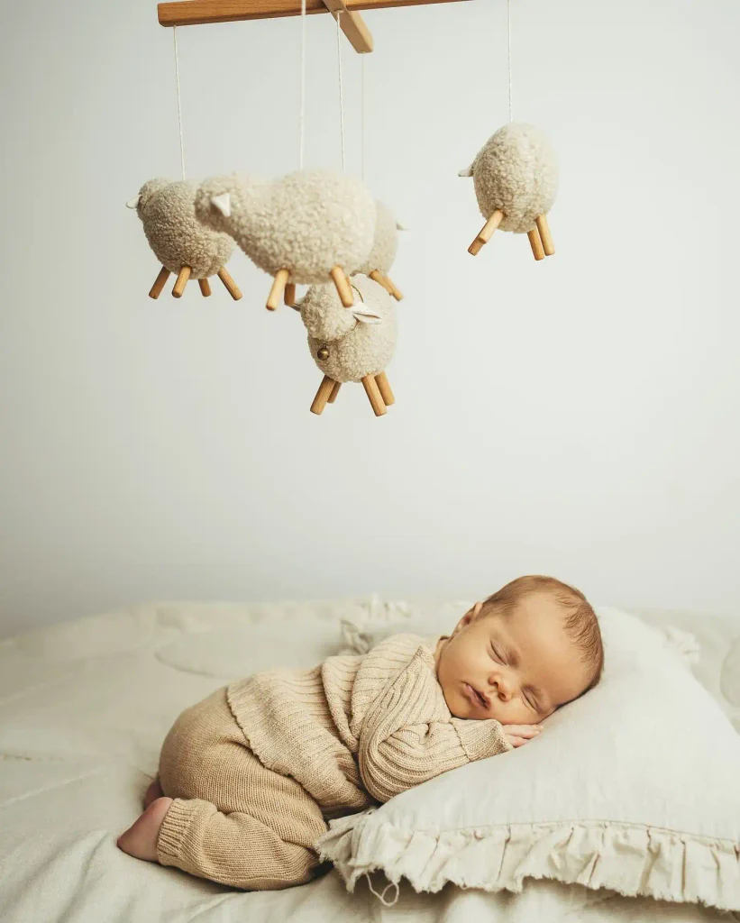 Sleeping Under a Wooden Sheep Mobile