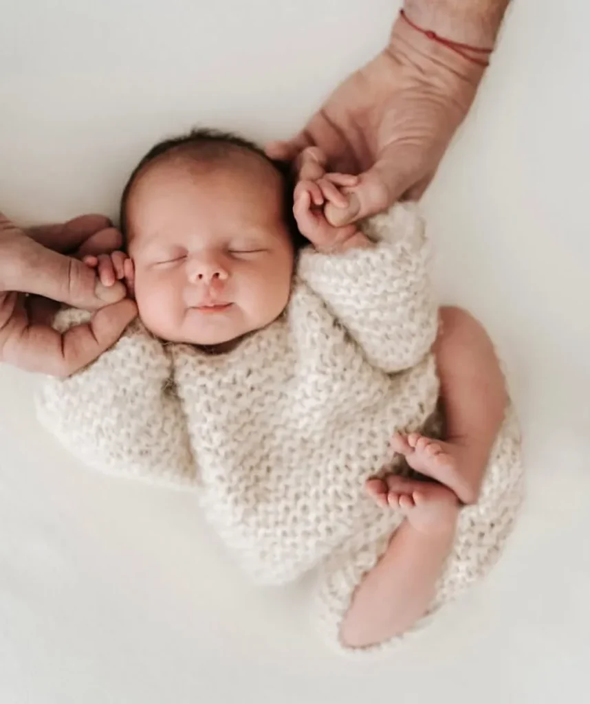Holding Tiny Fingers: A Two Hand Shot That Shows How Small Baby Is