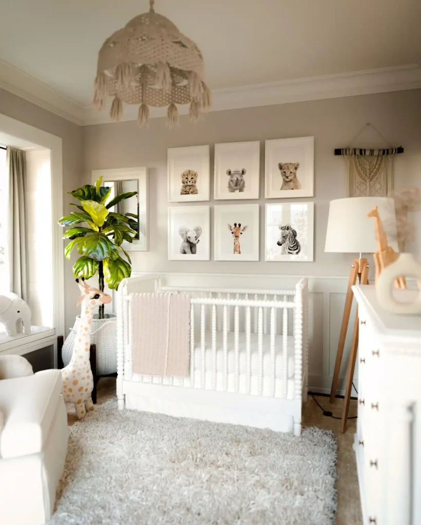Taupe nursery with six framed baby animal prints, a white spindle crib, a macrame pendant and a fiddle leaf fig